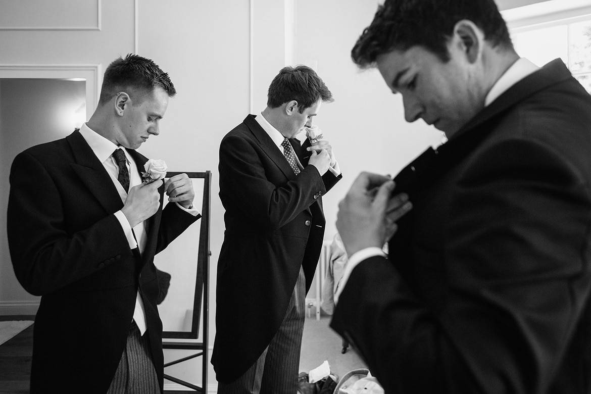 the boys fix their buttonholes