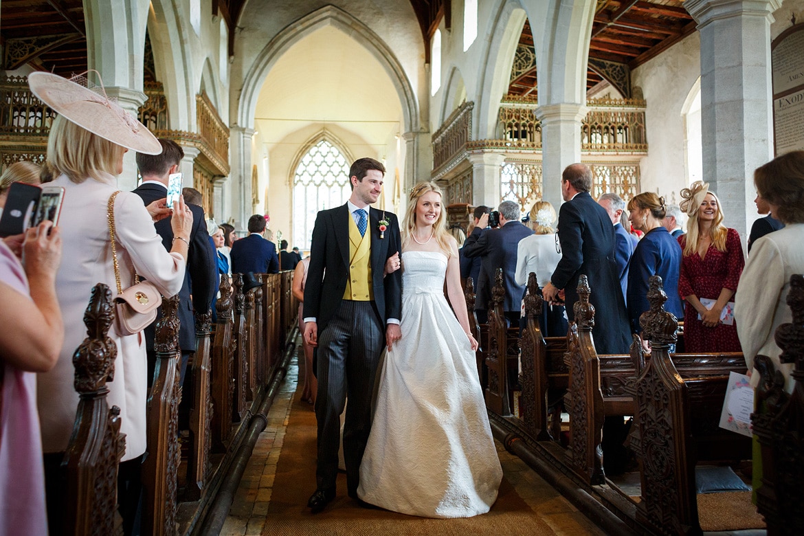 bride and groom walk down the aisle