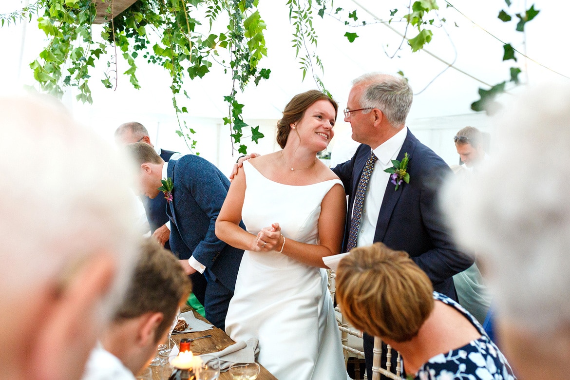 the bride and her father share a moment after the speeches