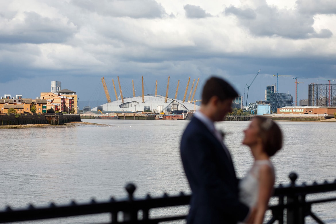 bride and groom with greenwich in the background