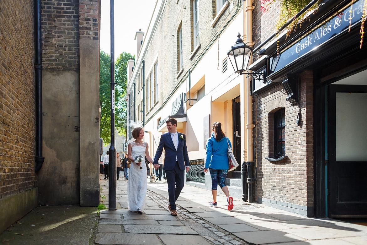 bride and groom walking through the streets of greenwich