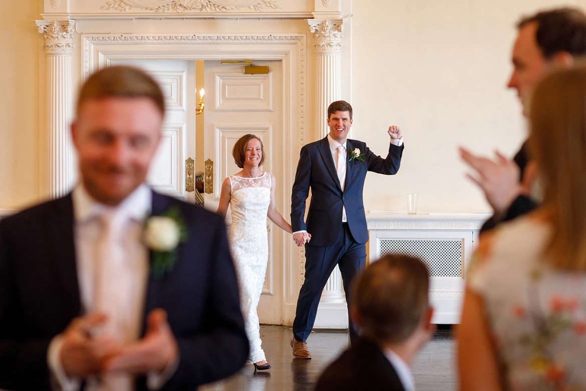 bride and groom enter the wedding breakfast