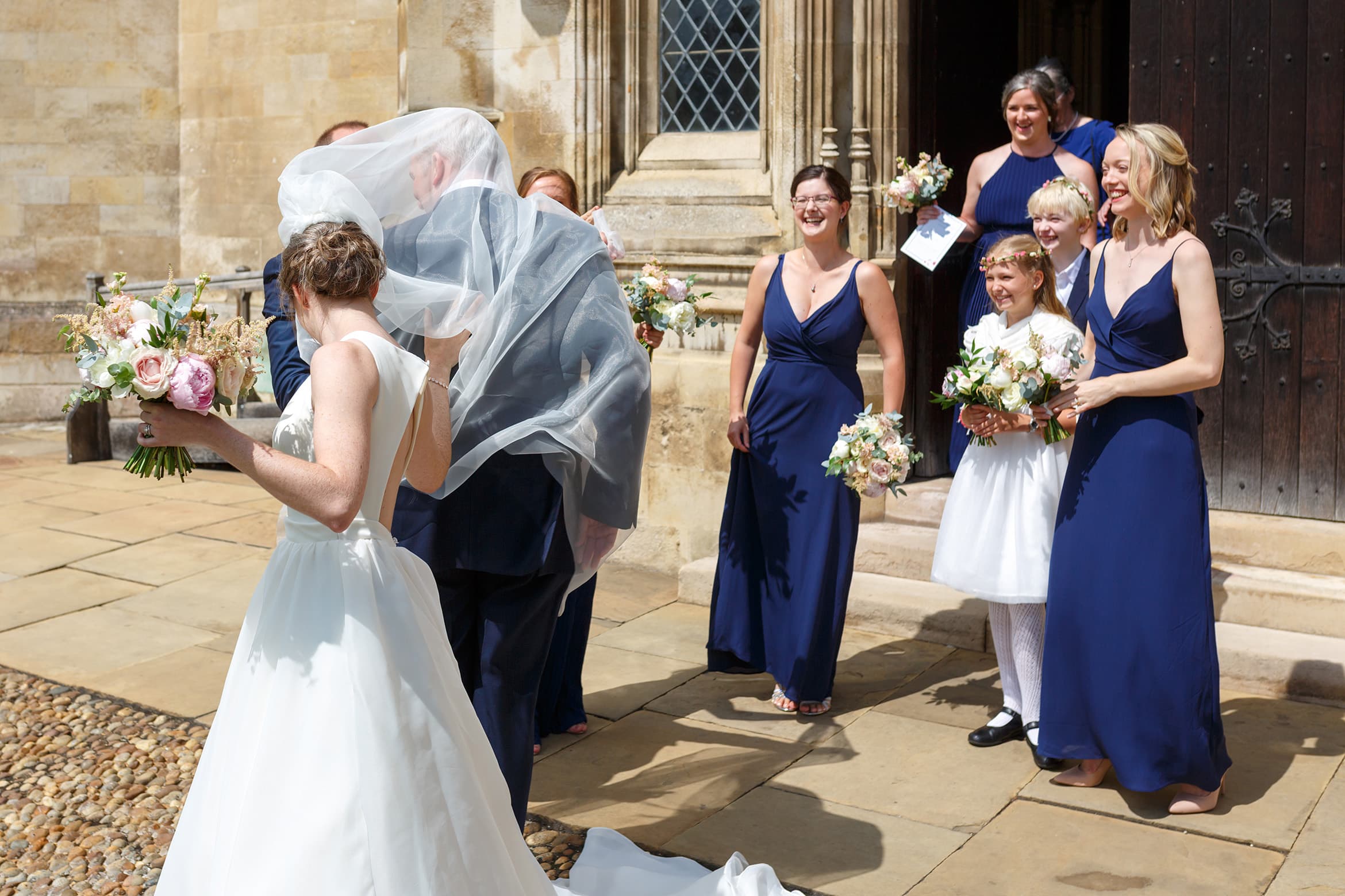 the brides veil blows in the wind