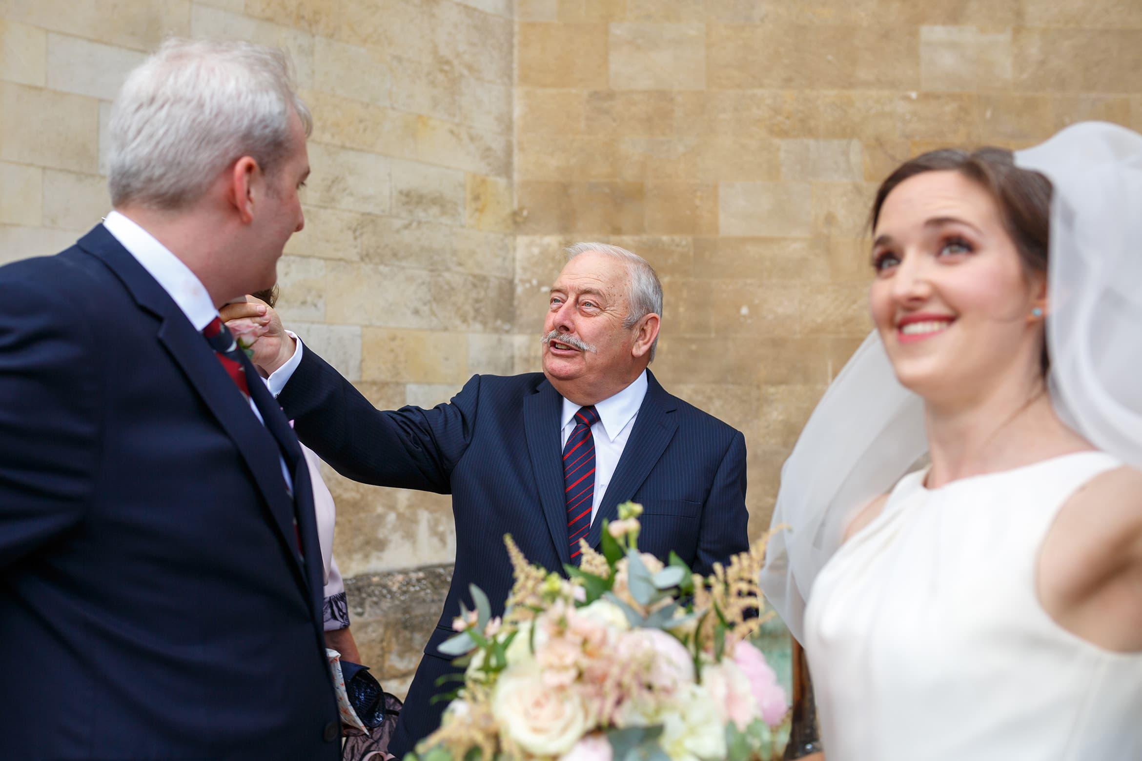 the grooms father congratulates his son