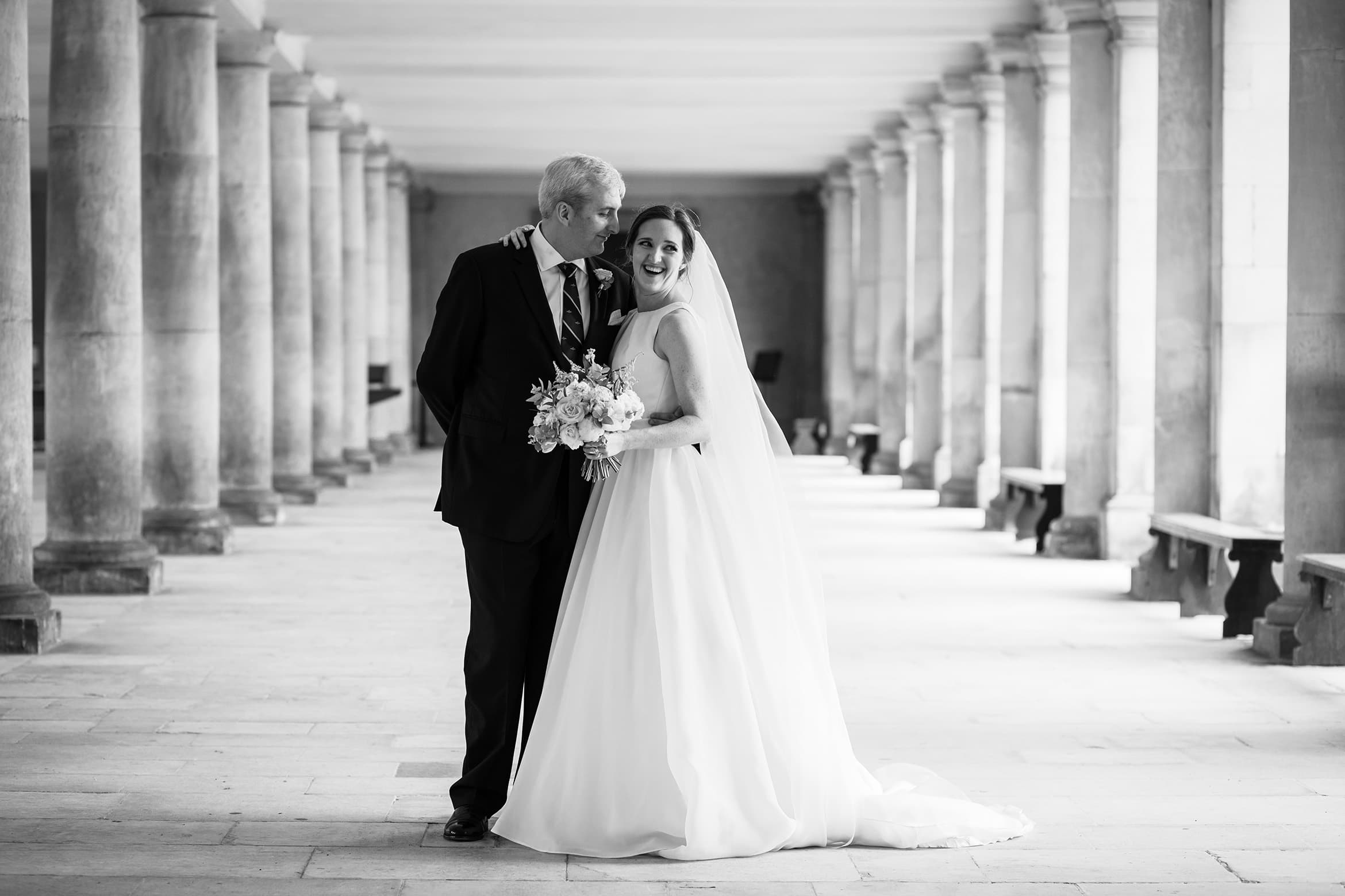 bride and groom in the cloisters at a trinity college wedding