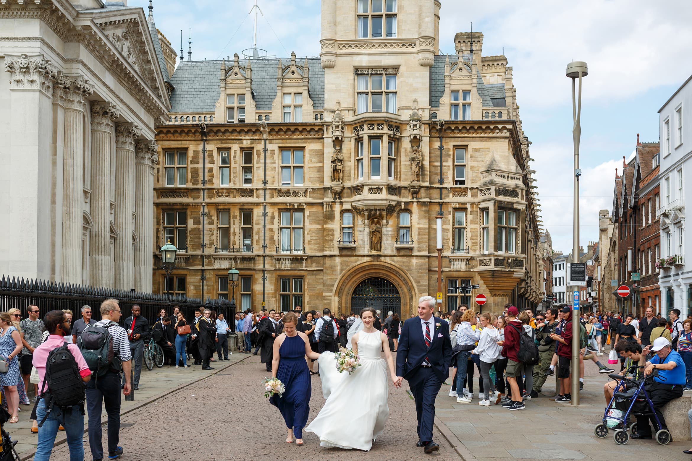 walking through the streets of cambridge on their wedding day