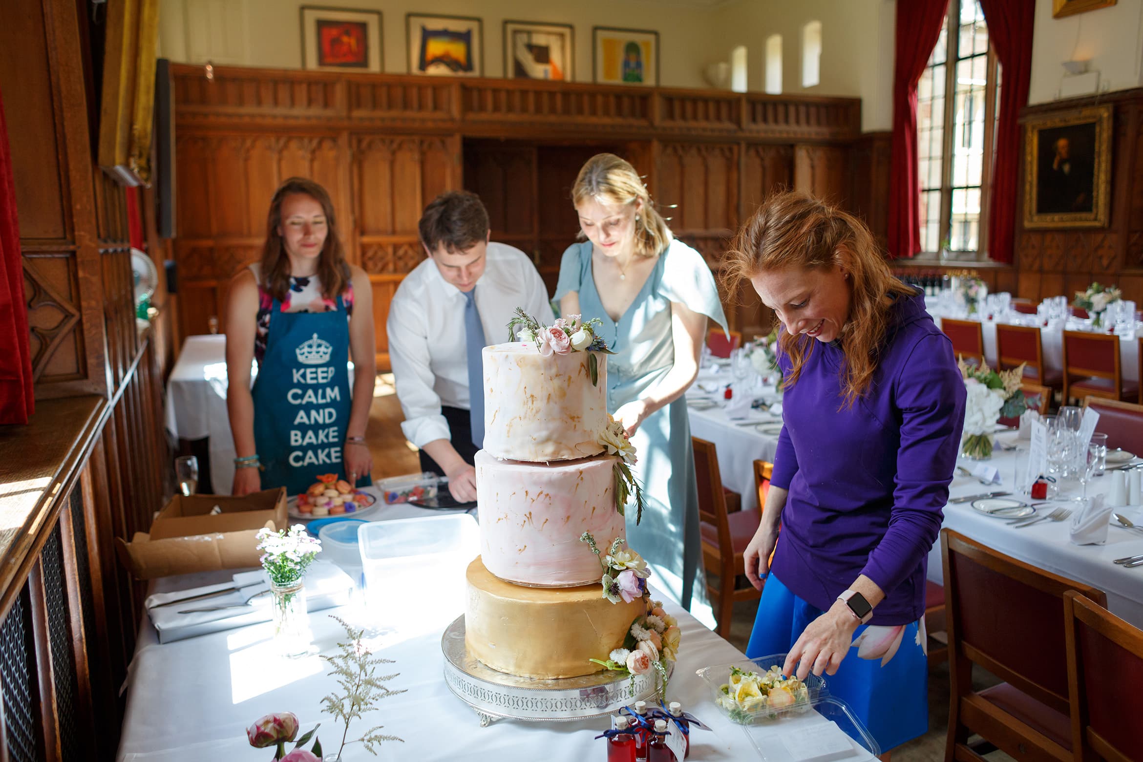 a friend applies the finishing touches to the wedding cake