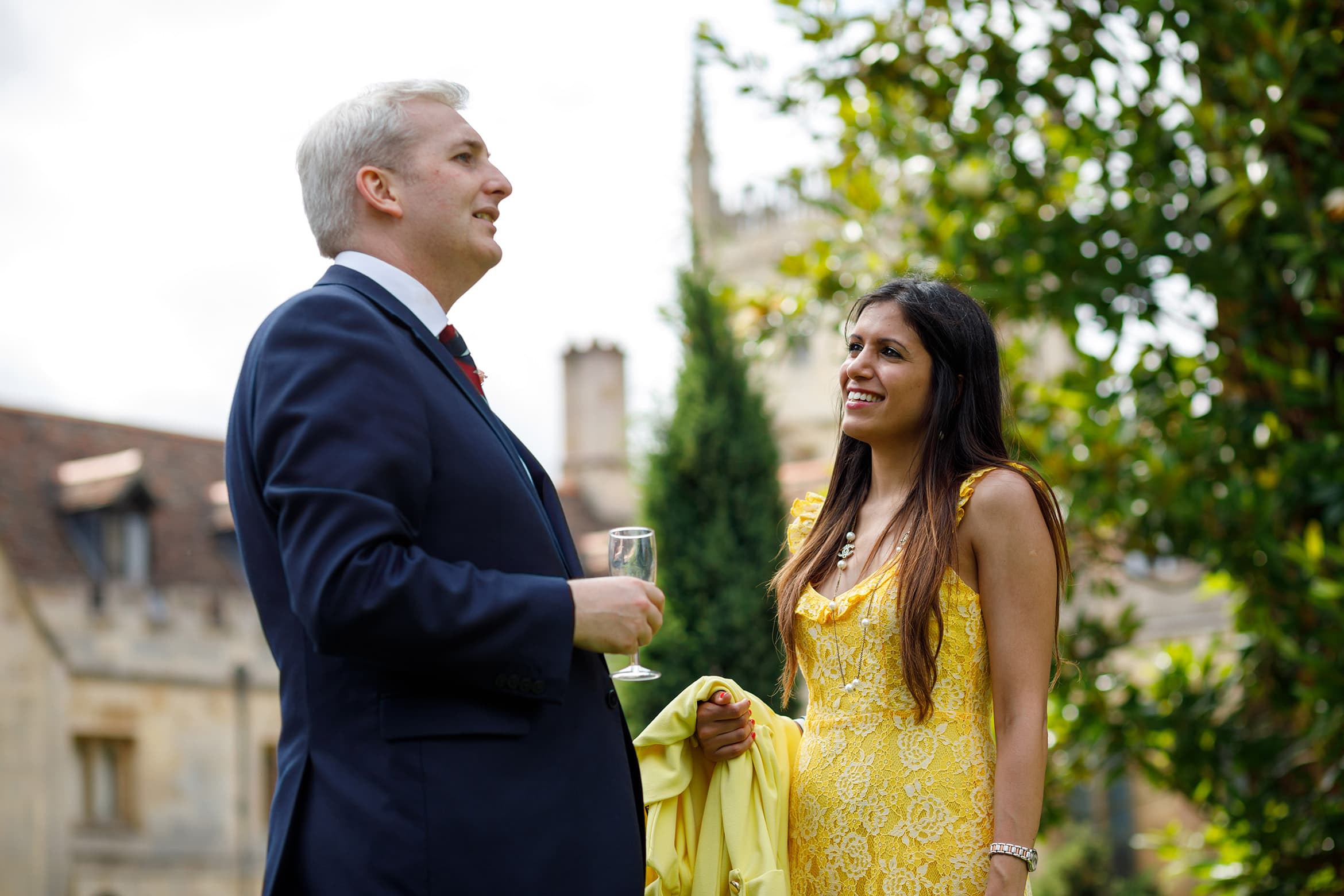 the groom talks to a wedding guest