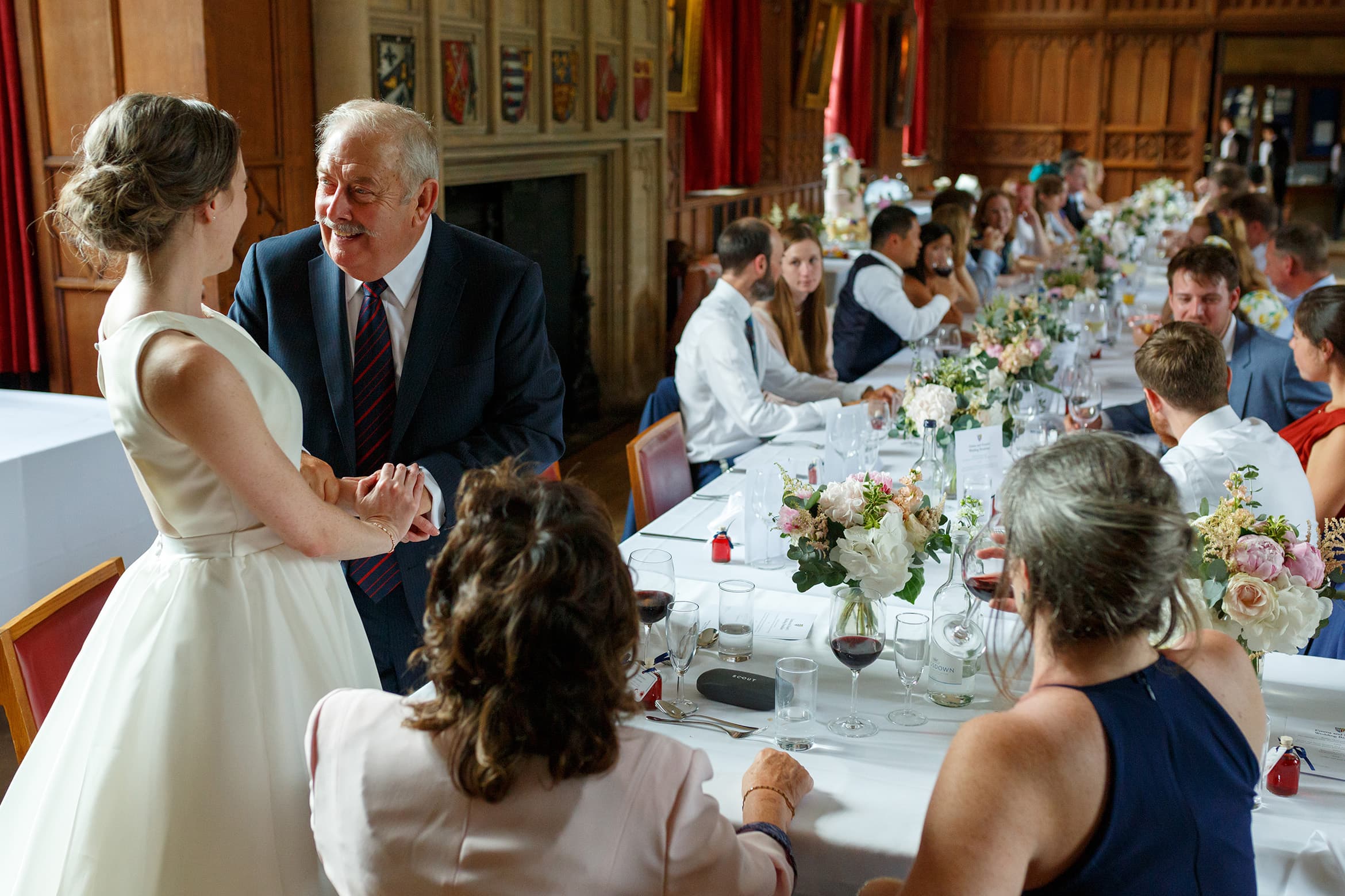 the father of the groom chats to the bride