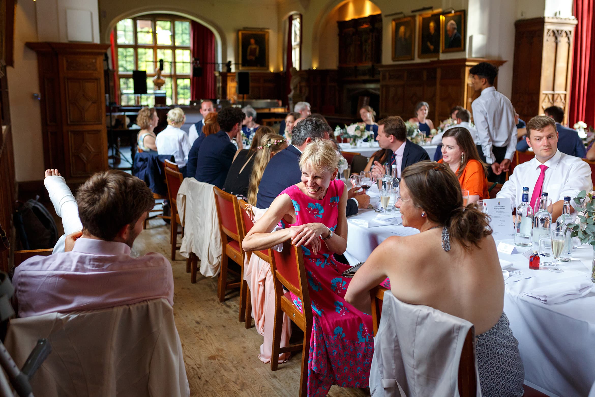 wedding guests chat in the dining hall at pembroke