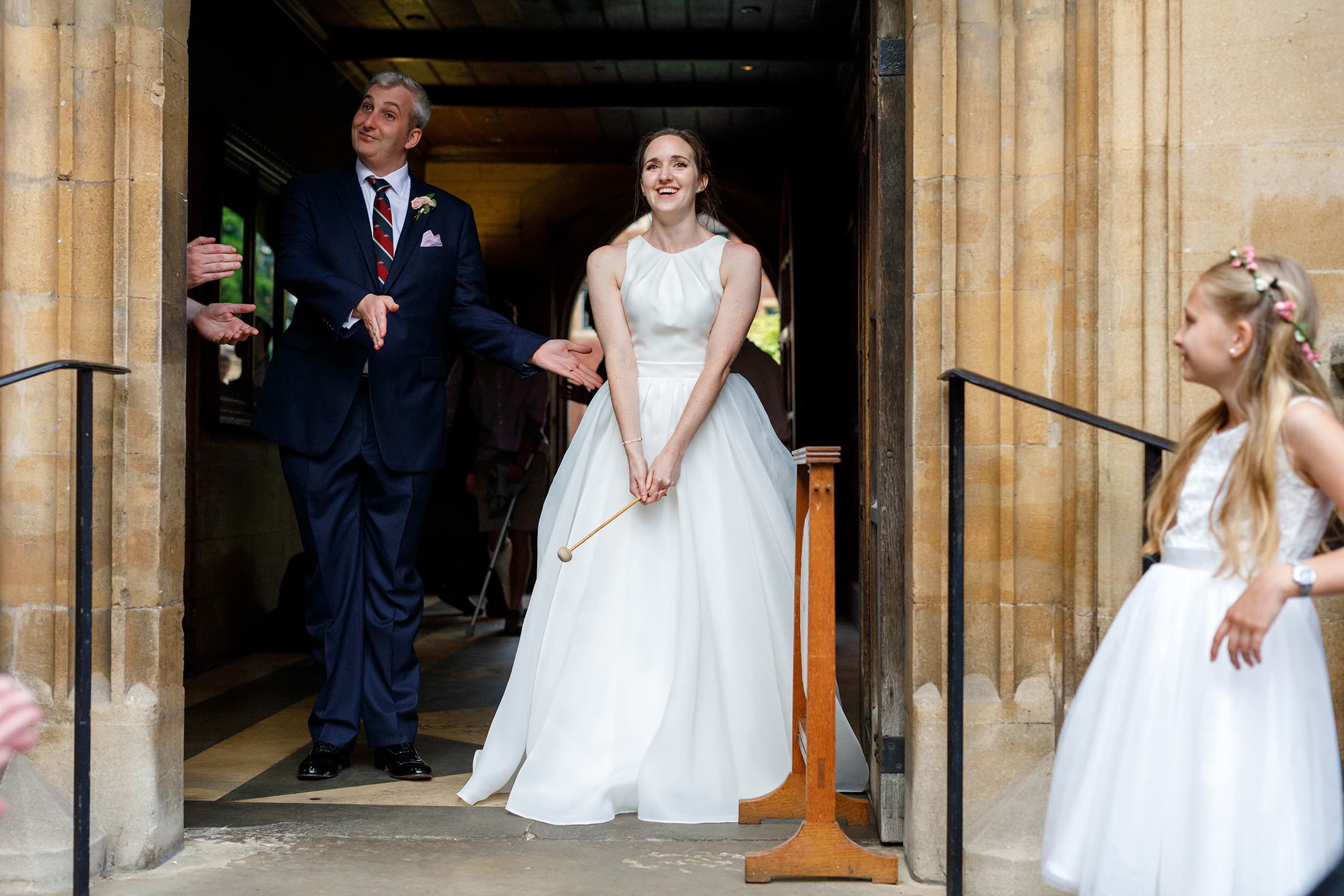 the bride bangs the gong to call guests inside