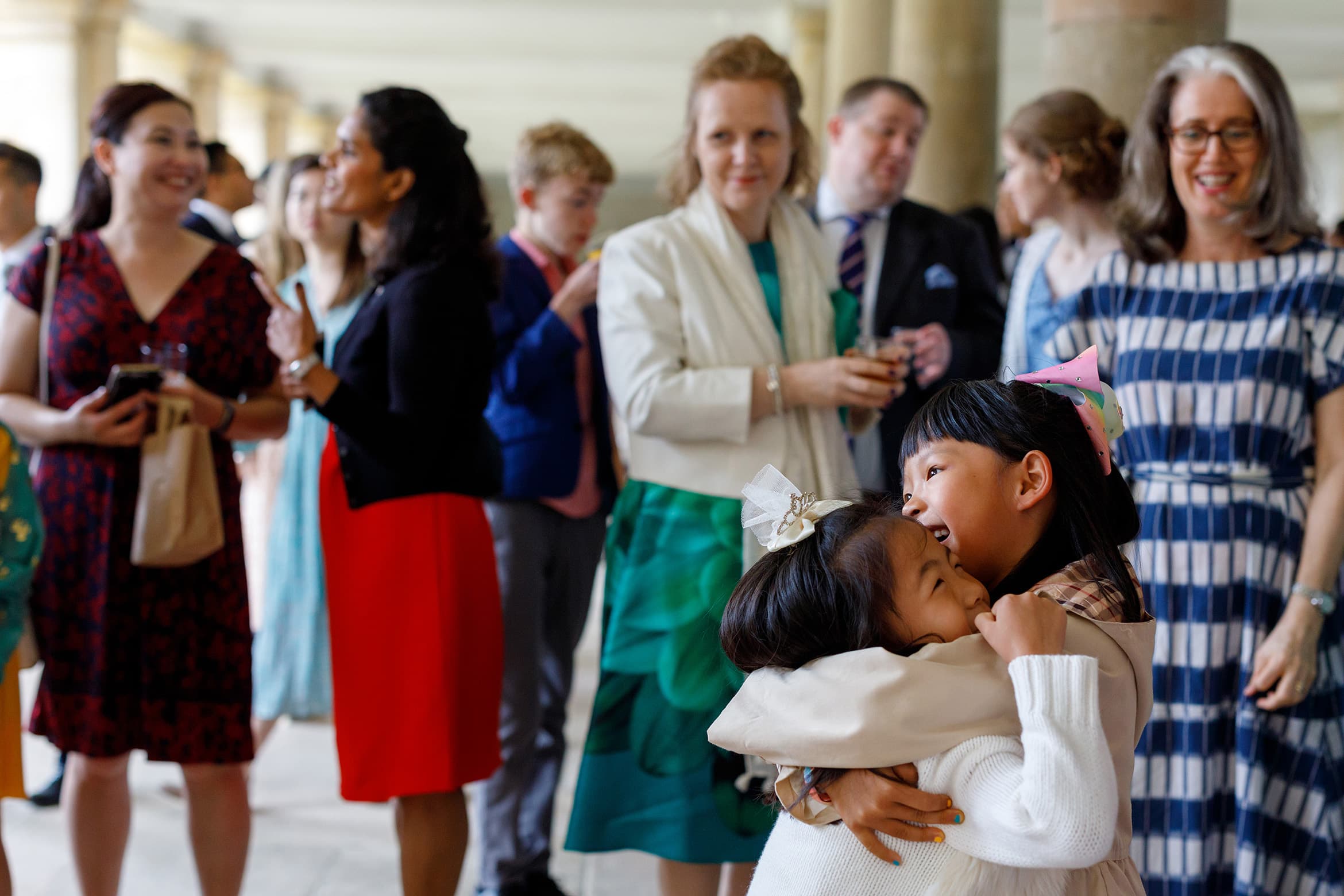 young wedding guests hug