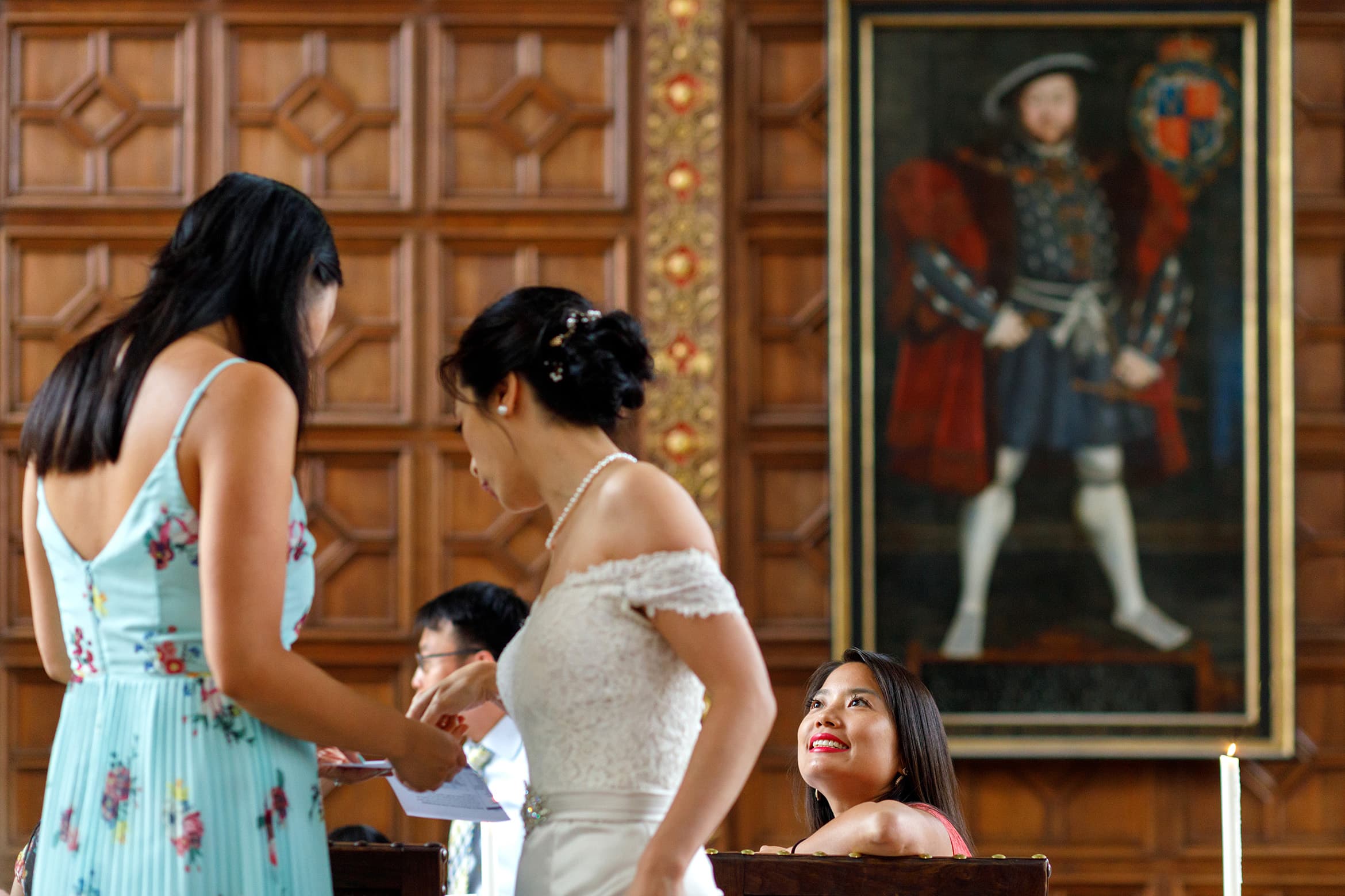 a wedding guest smiles at the bride