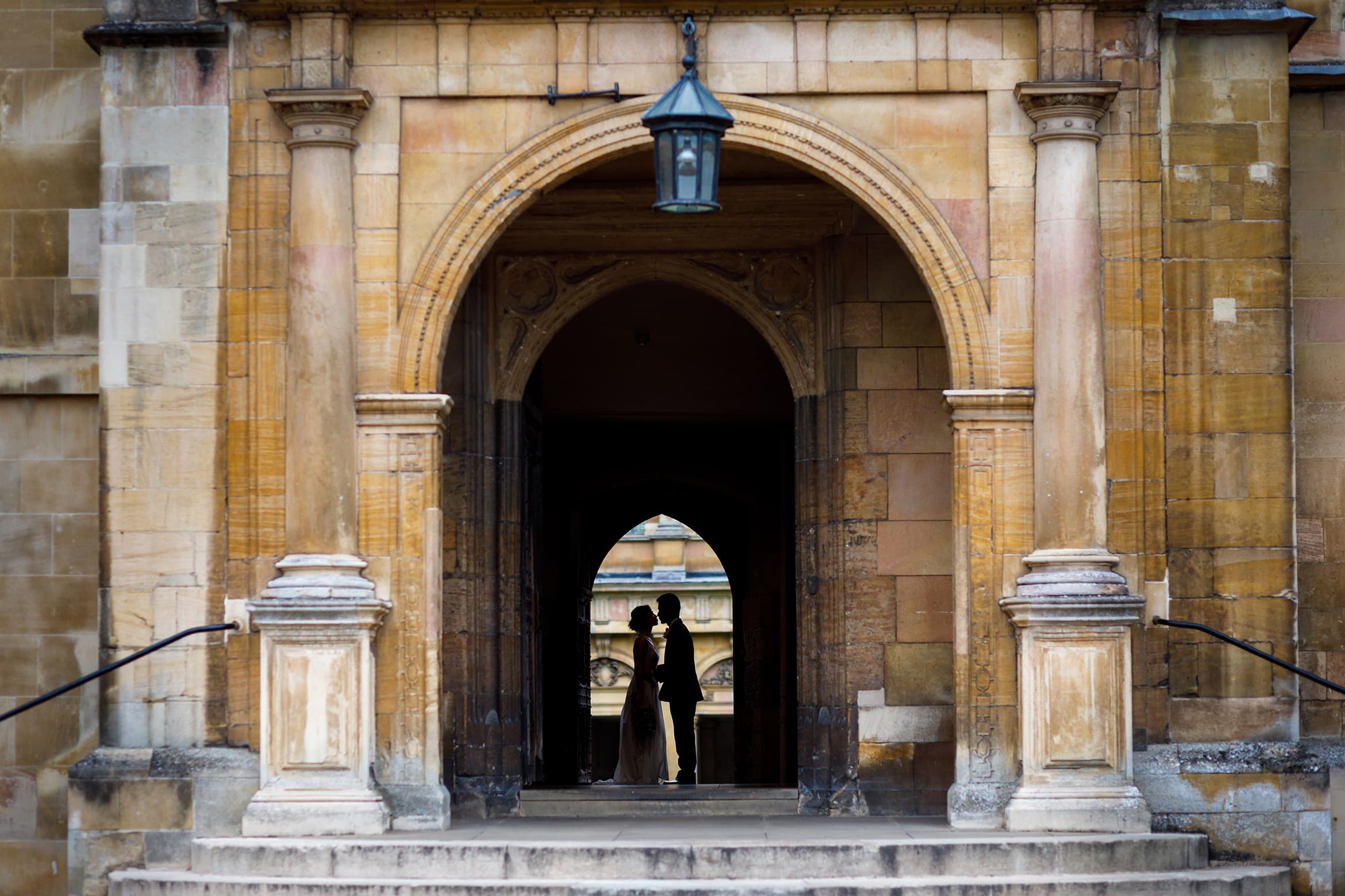 wedding silhouette outside the trinity college dining hall