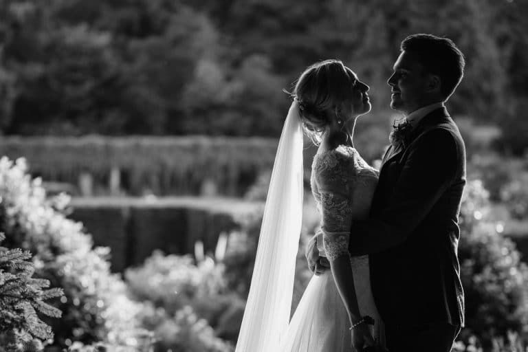 a backlit wedding potrait in the grounds of voewood in north norfolk